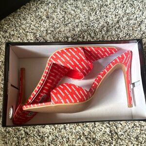 Red heartbreaker pumps